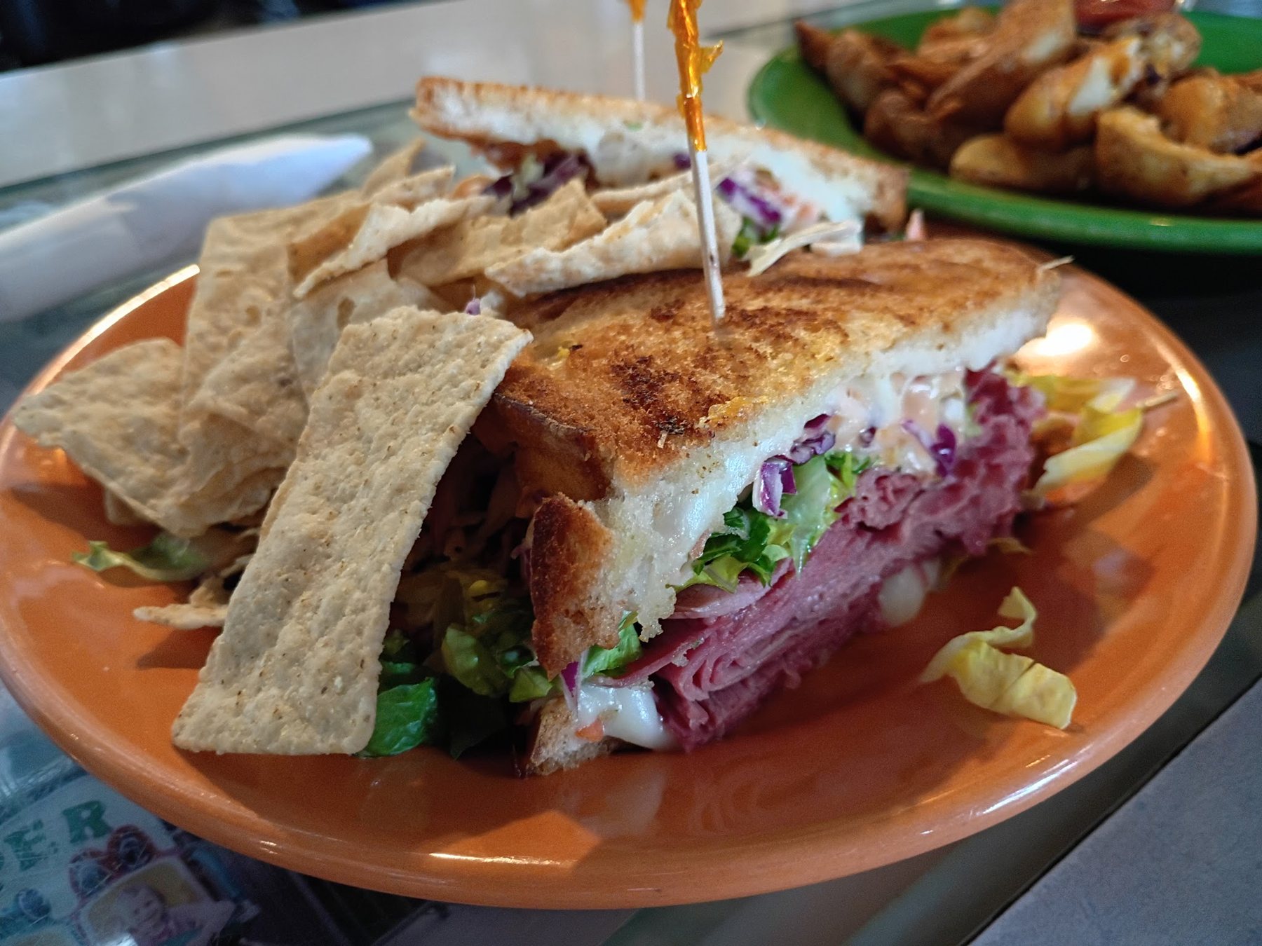 A grilled sandwich with tortilla chips